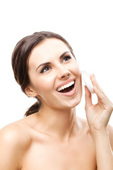 Young woman cleaning skin by cotton pad, over white