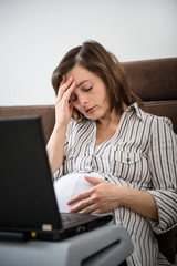 Working pregnant woman with headache