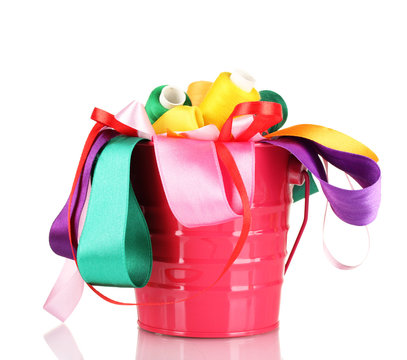 Color bucket with multicolor ribbons and thread isolated