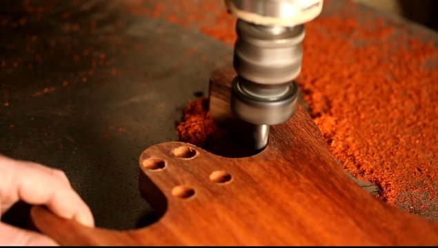 Milling ebony wood guitar body