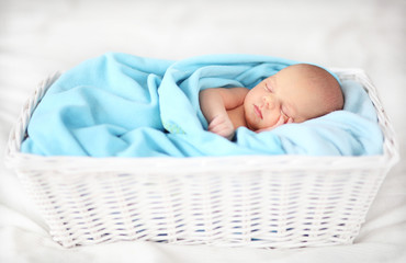 Baby sleeping in a basket