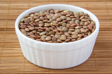 Green lentils in white ceramic cup