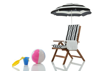Beach chair with umbrella and toys