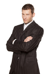 Portrait of a businessman with arms crossed on white background