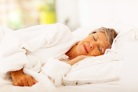 senior woman sleeping on bed