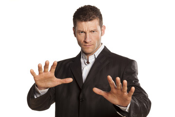 serious businessman with stop placed hands on white background