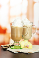 Fragrant coffee latte in glasses cups with vanilla pods,