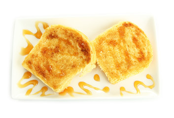 White bread toast with honey on plate, isolated on white