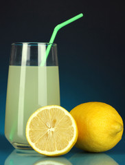 Delicious lemon juice in glass and lemons next to it
