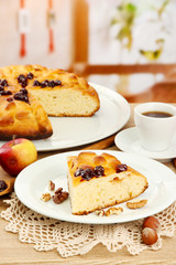 slice of tasty homemade pie with jam and apples and cup of