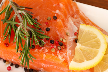 Fresh salmon fillet with herbals and lemon slices