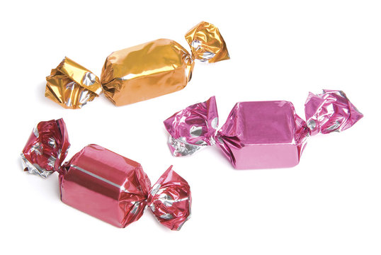 Three wrapped candies or sweets on a white background.