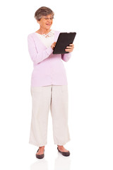happy senior woman using tablet computer isolated on white