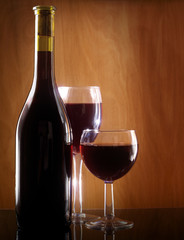 Red wine glass and Bottle on a wooden background