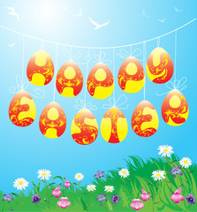 Hanging Easter eggs on spring blue sky background