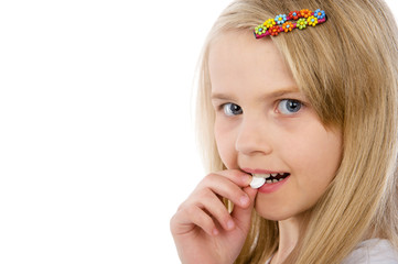 little girl with pills in her hand. isolated on white