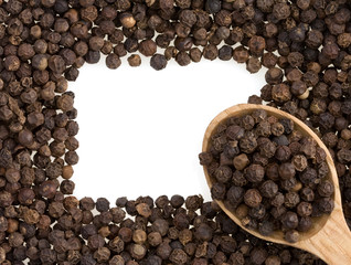 pepper and spoon on white