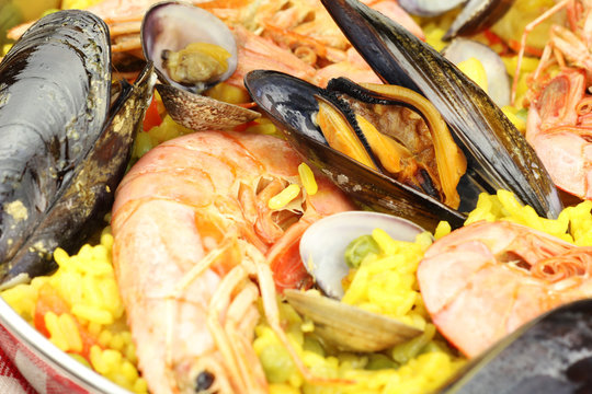 Closeup of seafood paella with mussels, clams and king prawns