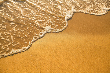 Fototapeta na wymiar Soft wave of the sea and beach sand texture.