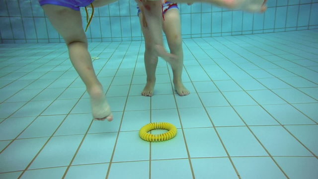 twins having fun at a swimming pool