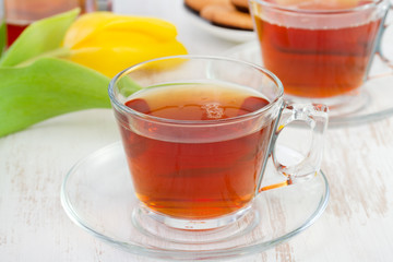 cups of tea with yellow tulip