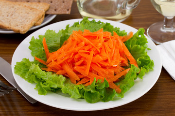 salad with fresh carrot on the white plate