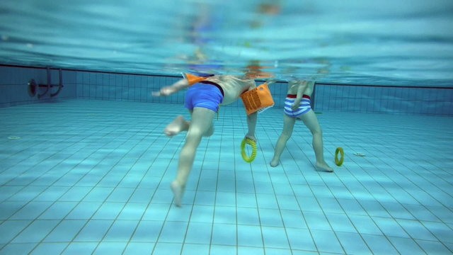 twins having fun at a swimming pool