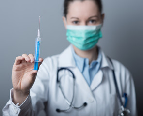 Doctor preparing syringe