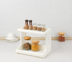 Plastic shelf with different seasonings bottles