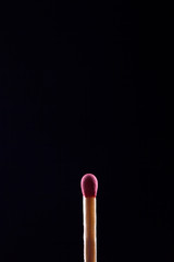 macro shot of match head, on black background