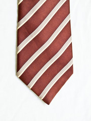 A striped brown and white tie isolated on white background.
