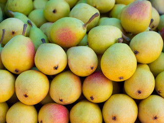 pears fruits stacked in a row on market