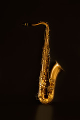 Obraz premium Sax golden tenor saxophone in black