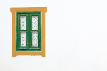 Traditional wooden window and white wall in Portugal