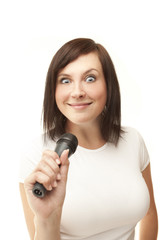 Young woman holding microphone and crazy smiling