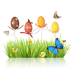 Easter colored eggs in grass, isolated on white background
