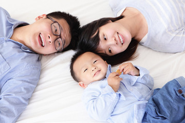 Happy family with children in bed