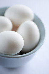 Blue bowl full of eggs, selective focus
