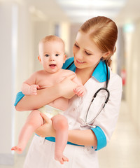 Pediatrician woman doctor holding baby © JenkoAtaman