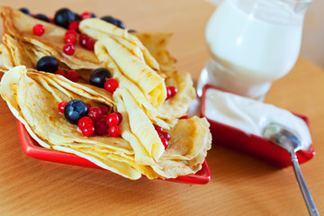  pancakes with  berries  and dairy cream