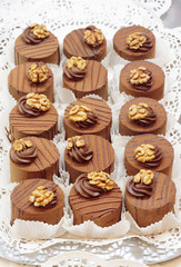 Closeup of many chocolate cakes with walnut