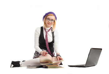 Girl with books and laptop, sitting on a white background.