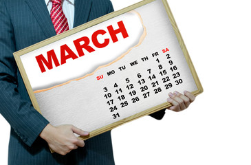 Business man holding black board - calendar 2013