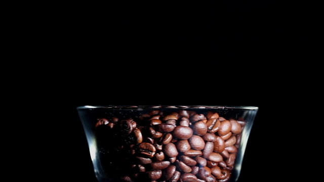 Grains of the roasted coffee in a glass. Horizontal view