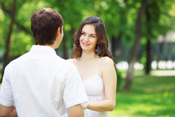 Obraz premium Young love Couple smiling under blue sky