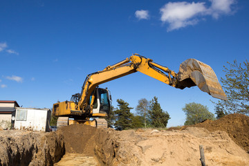 excavator digging sewer trenche