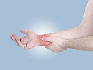 Acute pain in a man wrist. Male holding hand to spot of wrist pa