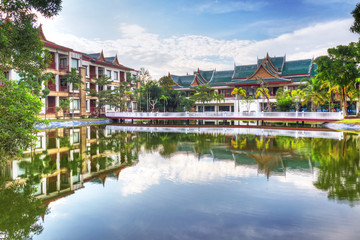Fototapeta na wymiar Oriental architecture reflected in the pond at sunrise, Thailand