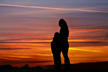 sunset siluet of women with children