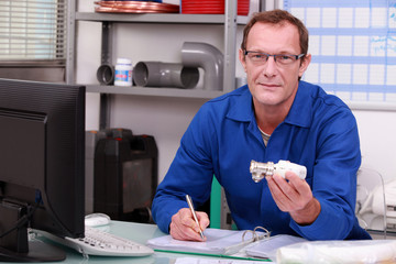 Plumber at a counter with a radiator valve